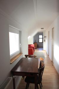 a dining room with a table and chairs in a room at A Kert Apartman in Rezi