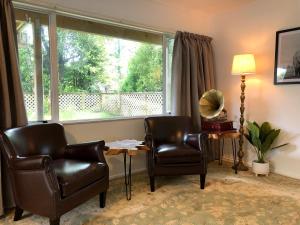 a living room with two chairs and a large window at Howards Mountain Lodge in National Park