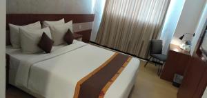 Postel nebo postele na pokoji v ubytování Xtra Hotel Bengkulu