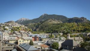 a view of a town with mountains in the background at Hôtel Mont-Brison in Briançon