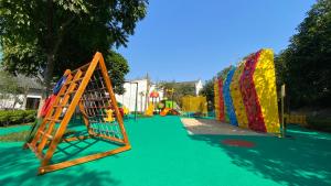 a playground with a slide and a play structure at Banyan Tree Yangshuo in Yangshuo