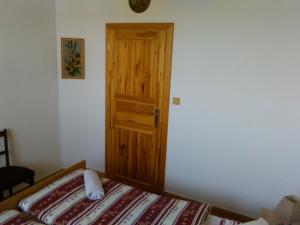 1 dormitorio con 1 cama y puerta de madera en Pension Otěvěk, en Trhové Sviny