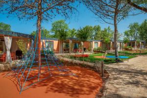 a playground in front of a group of houses at Lanterna Premium Camping Resort by Valamar in Poreč