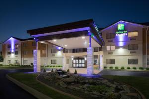 a hotel exterior at night with a fountain at Holiday Inn Express Louisville Northeast, an IHG Hotel in Louisville