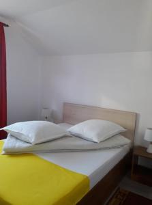 a bedroom with a bed with two pillows on it at Casa Maria in Vatra Dornei