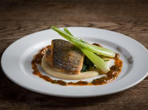 a white plate with some food on a table at Y Talbot in Tregaron