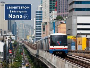 a train on a track in a city at On 8 Sukhumvit Nana Bangkok in Bangkok