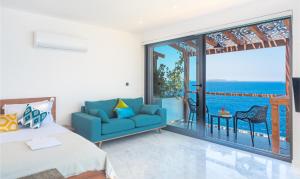 a bedroom with a blue couch and a view of the ocean at Mandalina Suites in Kaş