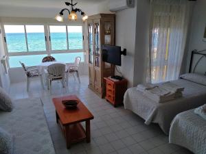 a living room with a bed and a tv and a table at Apartamentos Intercentro Algarrobo-Costa APARTAMENTOS TURÍSTICOS -INMOBILIARIA in Algarrobo-Costa +112 photos