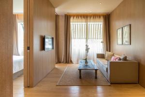 a living room with a couch and a table at The Margi in Athens