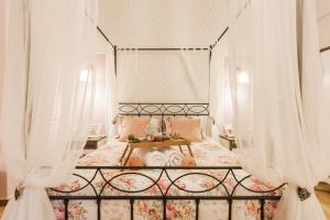 a bedroom with a canopy bed with white curtains at Syntagma private sweet safe double rooms with shared bathroom in Athens