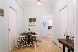 a kitchen and dining room with a table and chairs at Syntagma private sweet safe double rooms with shared bathroom in Athens +26 photos