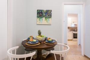a dining room table with a bowl of fruit on it at Syntagma private sweet safe double rooms with shared bathroom in Athens