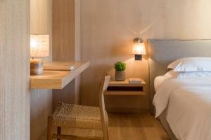 a bedroom with a bed and a night stand with a plant at The Margi in Athens