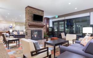 a living room with a fireplace and a tv at Staybridge Suites Seattle - Fremont, an IHG Hotel in Seattle