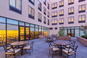 an outdoor patio with tables and chairs in front of a building at Staybridge Suites Seattle - Fremont by IHG in Seattle