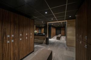 a locker room with wooden lockers and a desk at Fletcher Wellness-Hotel Kamperduinen in Kamperland
