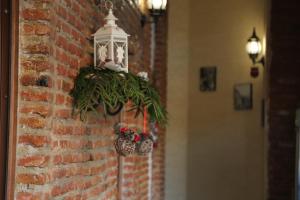 a christmas decoration on a brick wall with a lantern at Atlant Hotel in Tbilisi City