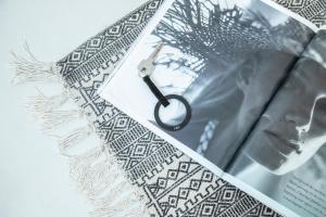 a book with a key on top of it at Nimbus Mykonos in Agios Stefanos