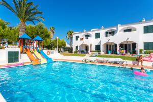a pool with a slide and a playground at Playa Parc Apartments in Son Parc +13 photos
