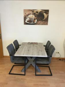 a table with chairs and a cup of coffee on it at Apartment Simone in Lörrach