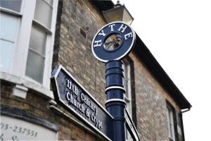 a street sign on a pole in front of a building at The Old Post Office Boutique Guesthouse in Hythe