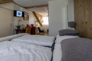two beds sitting next to each other in a room at B&B Aan het Park Eindhoven in Eindhoven
