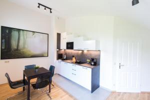 a kitchen with a table and a dining room at The Greenery Apartments in Vienna