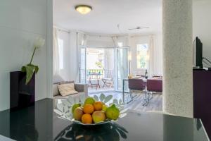 a bowl of fruit on a table in a living room at Apartment Gual 1 By SunVillas Mallorca in Port de Pollensa +22 photos