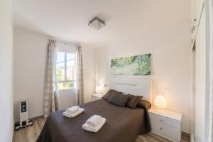 a bedroom with a bed with two towels on it at Apartment Gual 1 By SunVillas Mallorca in Port de Pollensa