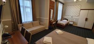 a living room with a couch and a table at Hotel Kamienica in Siedlce +203 photos