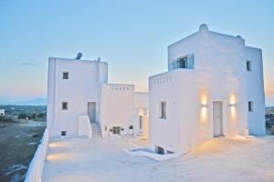 a view of a white house at dusk at Villa kleio Naxian album with private pool in Glinado Naxos