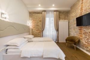 Posteľ alebo postele v izbe v ubytovaní Pellegrini Luxury Rooms