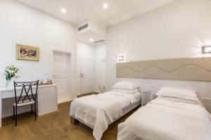 Posteľ alebo postele v izbe v ubytovaní Pellegrini Luxury Rooms