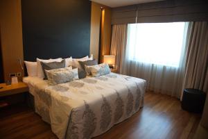 a bedroom with a large bed with a window at CPAnkara Hotel in Ankara