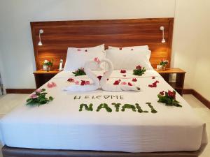 a bed with a sign that says let the marry at Batuta Maldives Surf View in Thulusdhoo