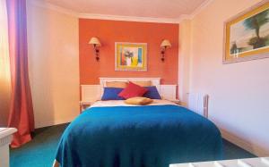 a bedroom with a bed with a blue blanket at ARTEMIS SUITE in Barbizon +10 photos