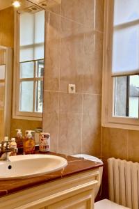 a bathroom with a sink and a mirror at ARTEMIS SUITE in Barbizon