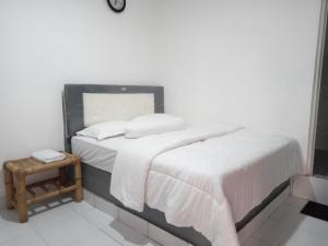 Ένα ή περισσότερα κρεβάτια σε δωμάτιο στο Gani Homestay