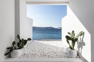 a room with a view of the ocean at Nimbus Mykonos in Agios Stefanos