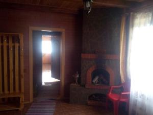 a room with a door and a fire place at Эко отель и баня in Kosharishche