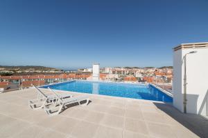 a swimming pool on the roof of a building at Sunset - Holiday Apartment - By SCH in São Martinho do Porto