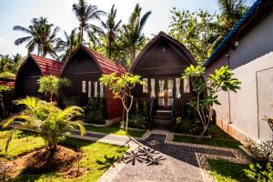 a house in the middle of a garden at Sekar Ayu Spa Salon & Bungalow in Nusa Penida