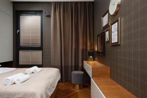 a hotel room with two beds with towels on them at Apartments Konstruktorska by Renters Prestige in Warsaw