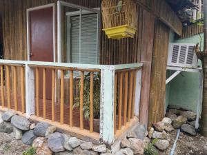 a wooden fence in front of a house at Villa Catalina Bora 3 Resort in Nabas