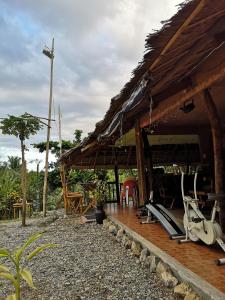 a house with a surfboard sitting outside of it at Villa Catalina Bora 3 Resort in Nabas