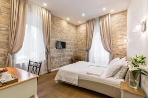 Posteľ alebo postele v izbe v ubytovaní Pellegrini Luxury Rooms