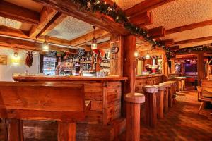 a bar in a restaurant with wooden walls at Le Vieux Valais in Ovronnaz +47 photos