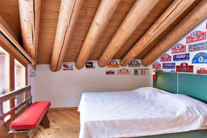 a bedroom with a bed and a wooden ceiling at Chesa Romana - Silvaplana in Silvaplana