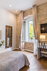 Posteľ alebo postele v izbe v ubytovaní Pellegrini Luxury Rooms